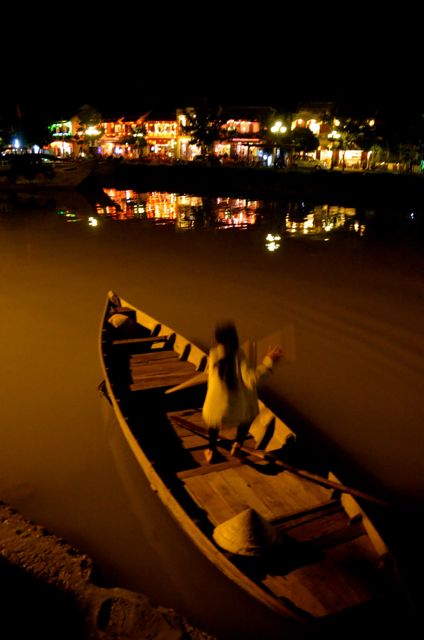 woman in boat in hoi an vietnam at night